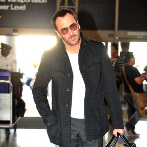 Tom Ford and his husband Richard Buckley head through LAX with their son Alexander