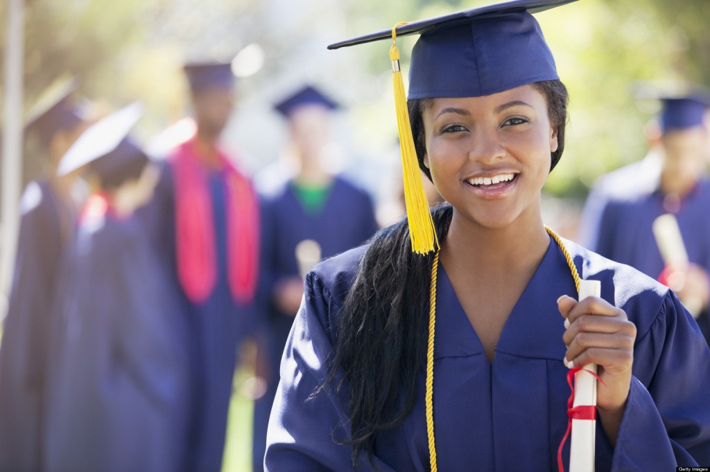 Smiling graduate holding diploma