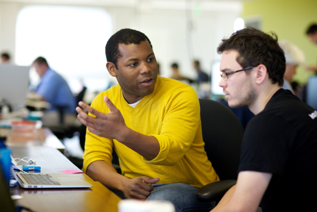 Chris Bennett (center) CEO and co-founder of Central.ly, discusses a business plan with Brett Welch, CEO of Switchcam, at the internet startup incubator space 500 Startups in Mountain View, California, Tuesday, November 15, 2011. Bennett is one of four African-American tech entrepreneurs behind Black Founders, a group that is trying to create opportunities for other African-Americans in the tech industry. Thor Swift For The Bay Citizen