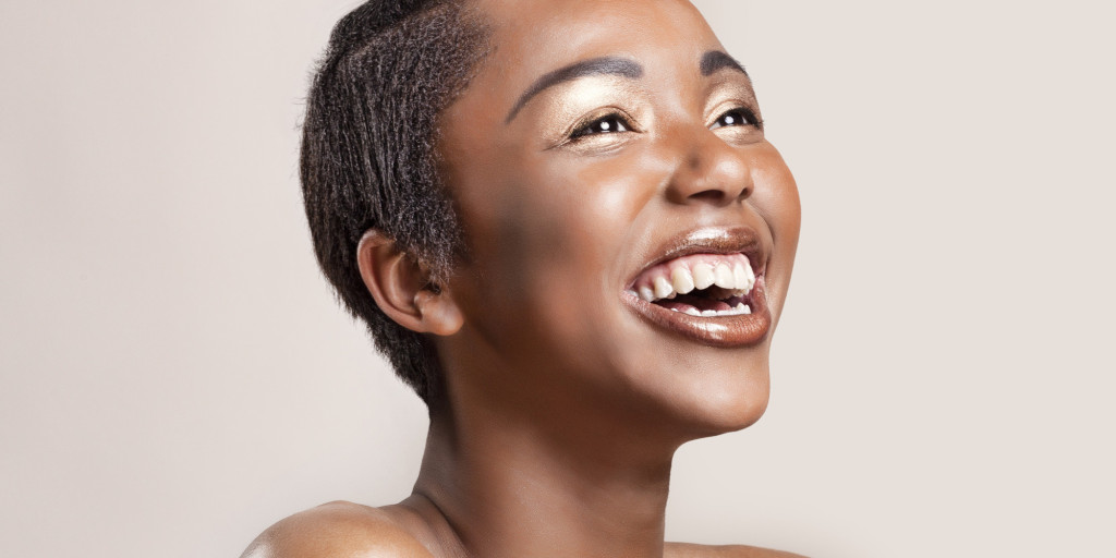 Portrait of a happy woman with glowing shiny skin