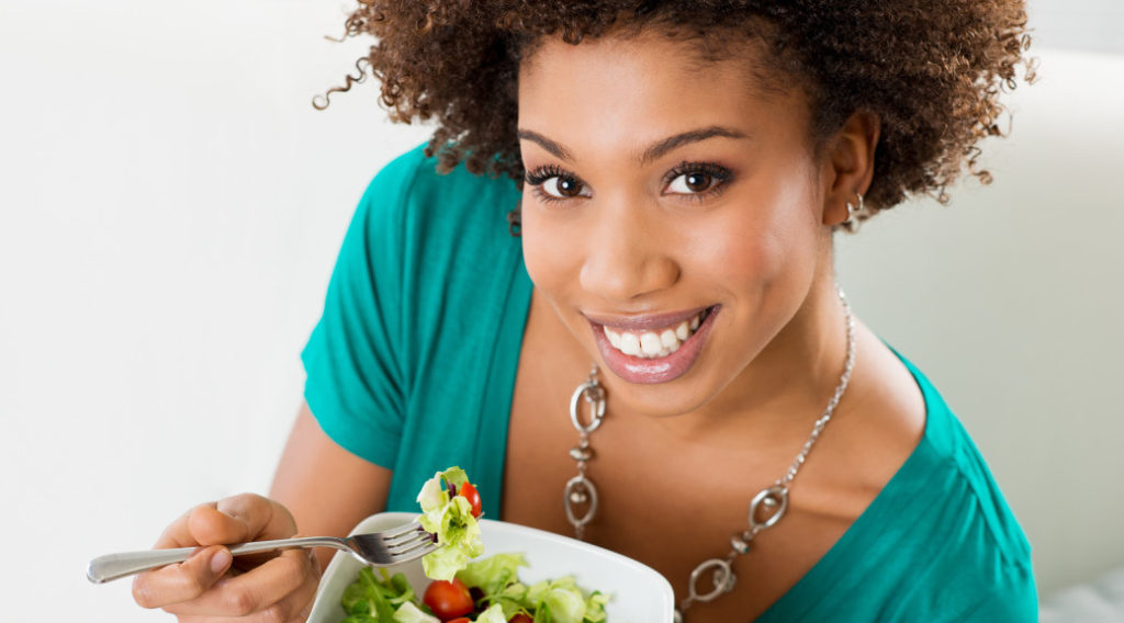 Close-up Of Beautiful African American Woman Eating Salad